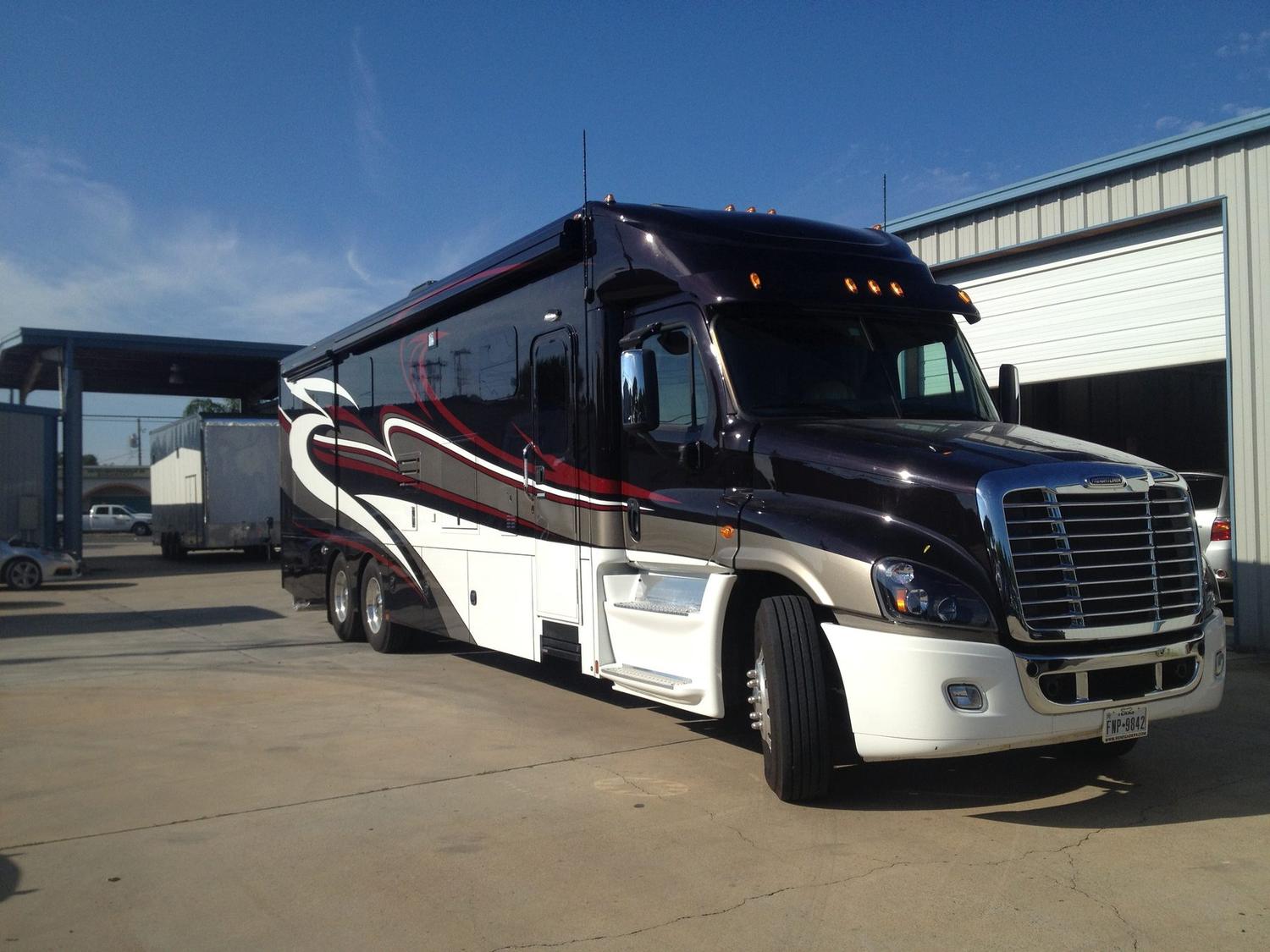 Renegade Freightliner motorcoach repainted in black, red, white and silver